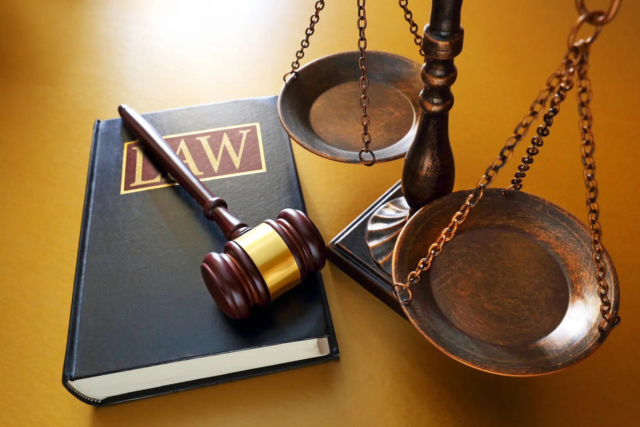 Gavel, law book, and scales of justice.